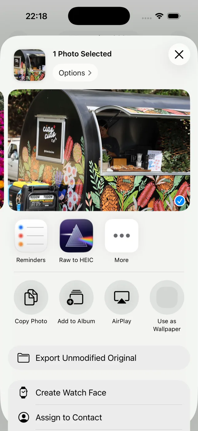 The iOS Share sheet in Photos with the RawToHEIC action